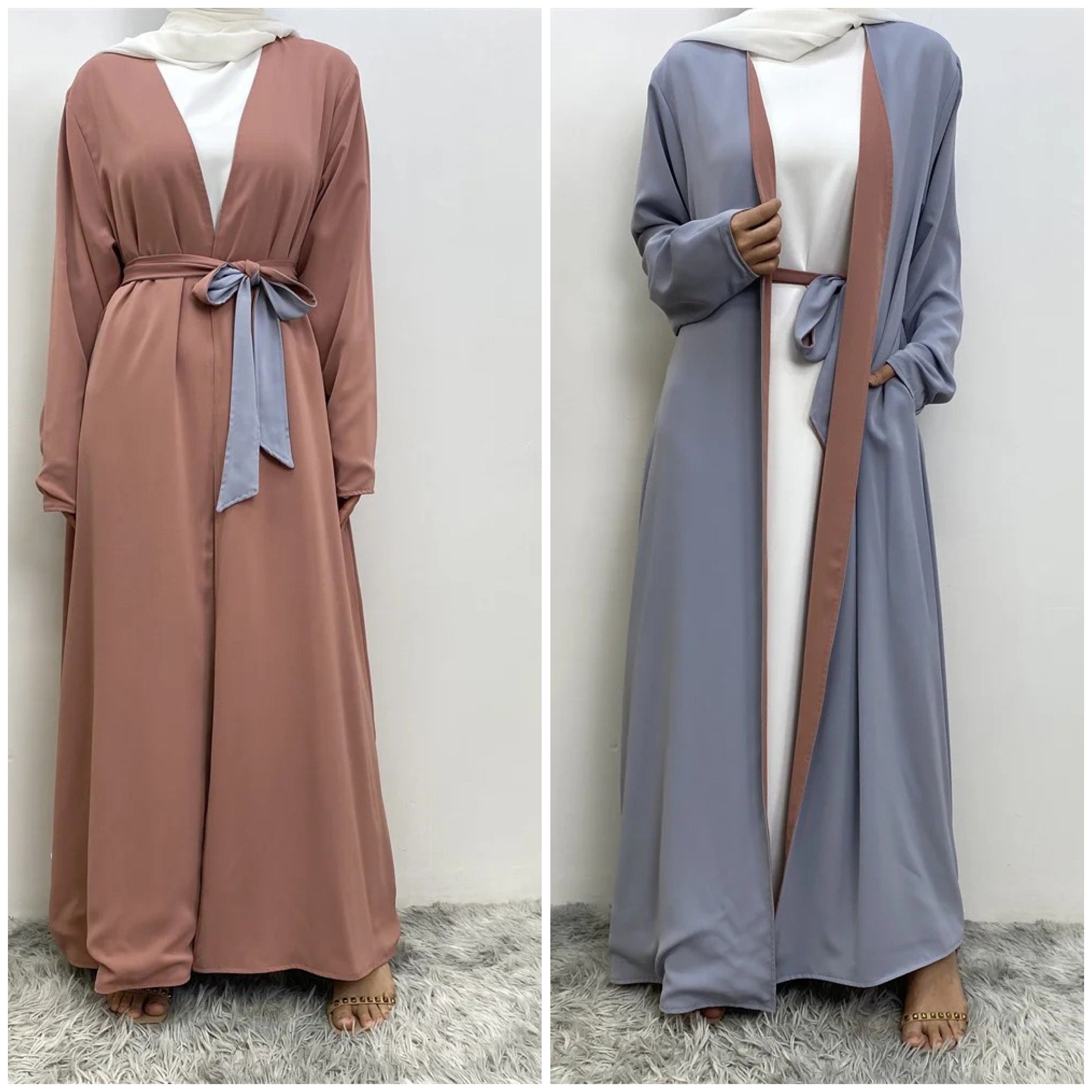 Two long dresses, one maroon and one brown, on a neutral background.