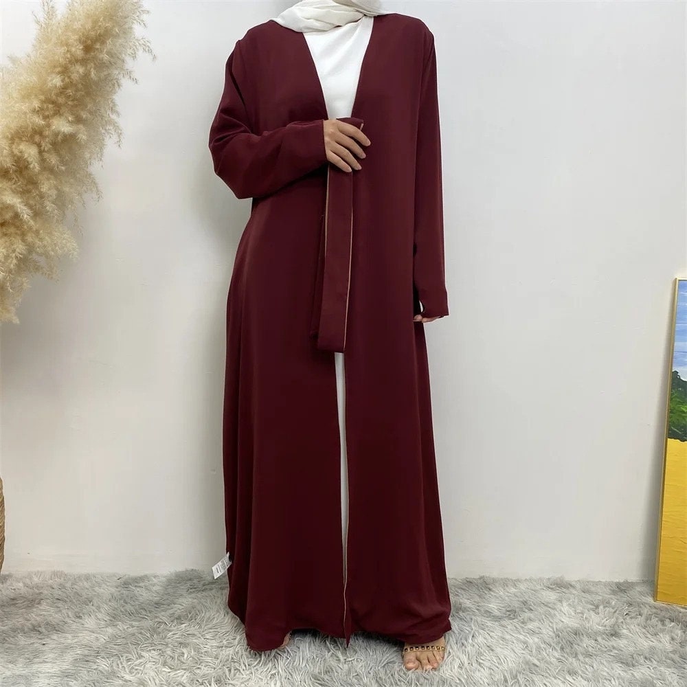long dresses, one maroon and one brown, on a neutral background.