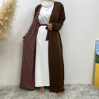 long dresses, one maroon and one brown, on a neutral background.

