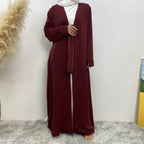 long dresses, one maroon and one brown, on a neutral background.