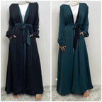 long dresses, one maroon and one brown, on a neutral background.

